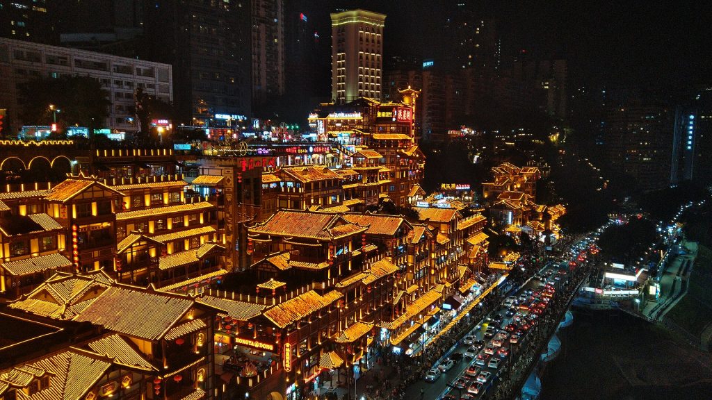 Hongya Cave glowing at night as seen from Qiansimen Bridge in Chongqing.