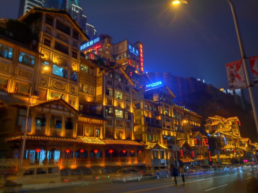 Hongya Cave rising above the riverside in Chongqing during the day.