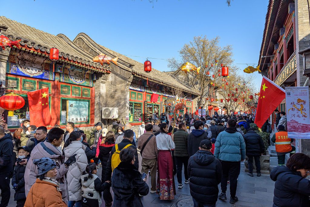 Liulichang Culture Street East Street in Beijing with traditional architecture and pedestrians.