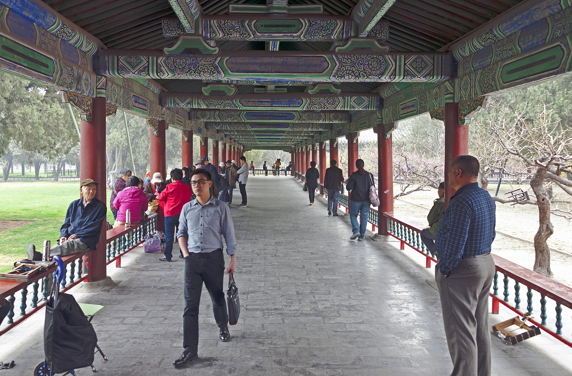 People gathering in the long corridor area of Temple of Heaven Park in Beijing.