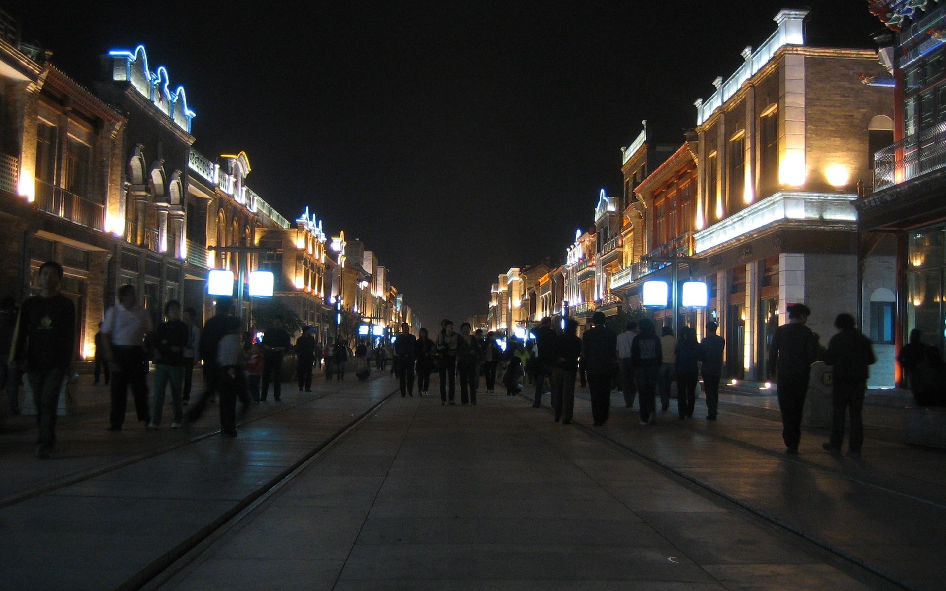 Qianmen Street in Beijing with historic-style storefronts and pedestrians.