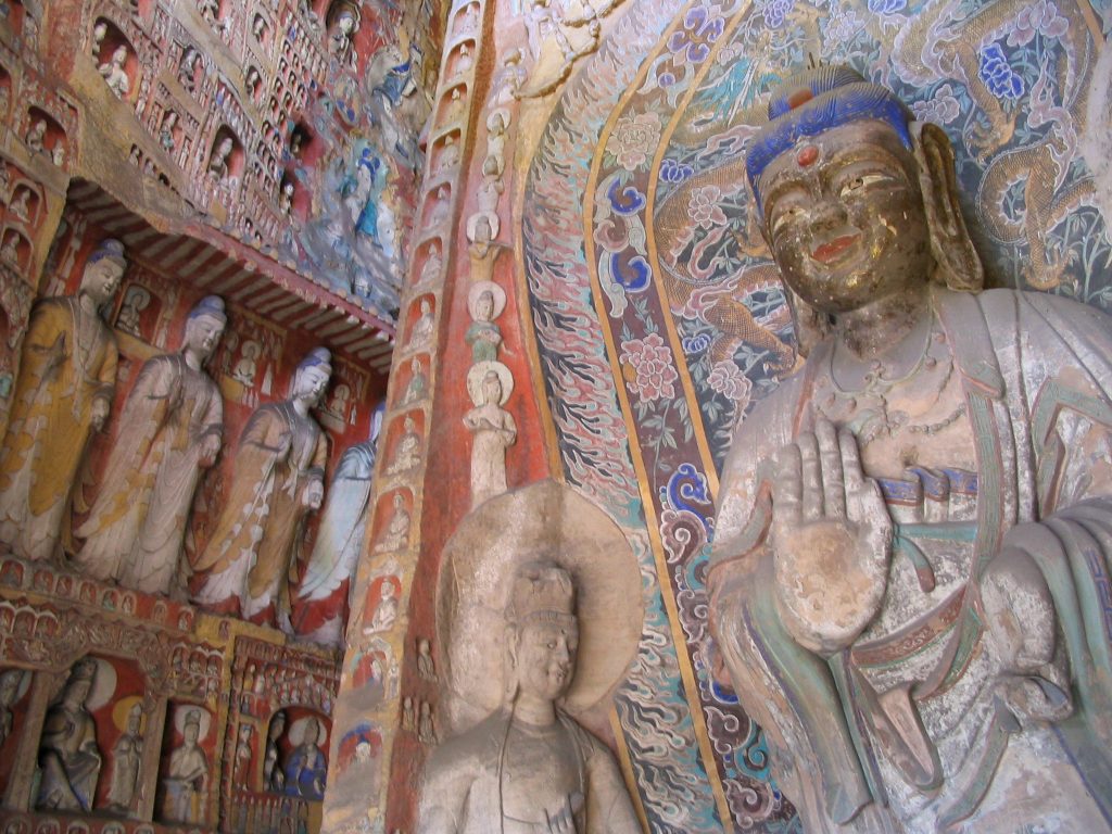 Side wall statues and carved details in Cave 11 at the Yungang Grottoes.