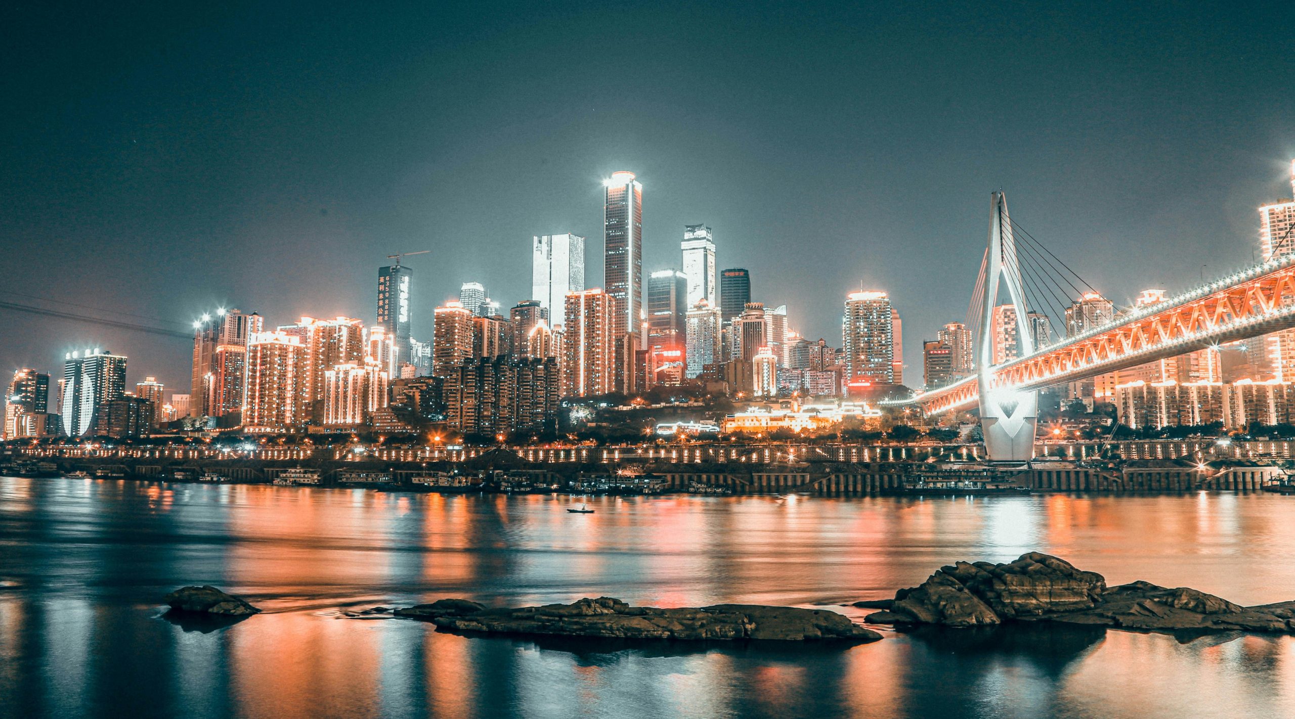 Chongqing skyline at night with illuminated buildings reflected in the river