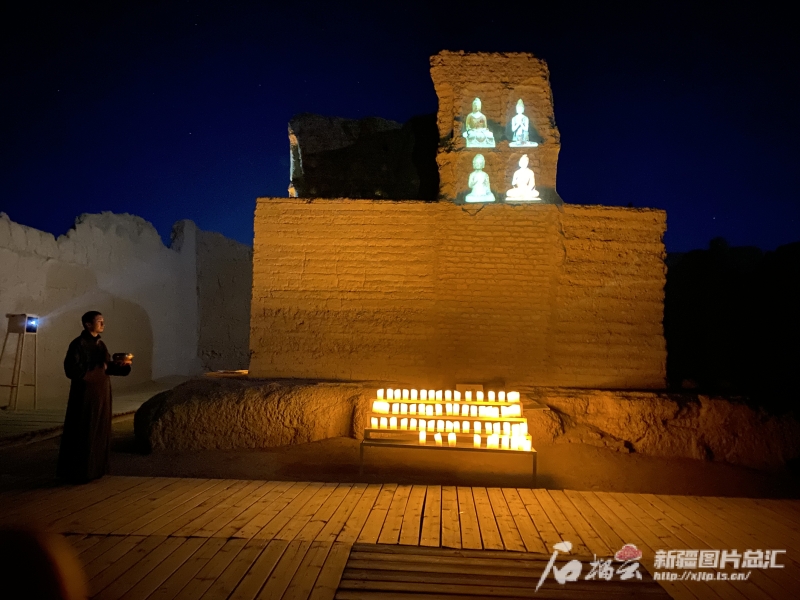Jiaohe night performance beside the illuminated earthen walls.