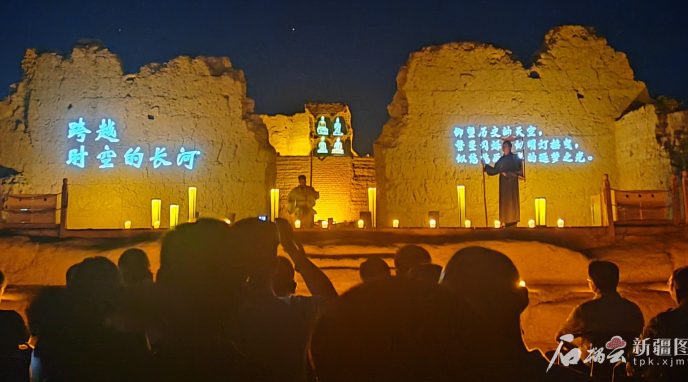 Night Tour of Jiaohe performance with lit earthen walls.