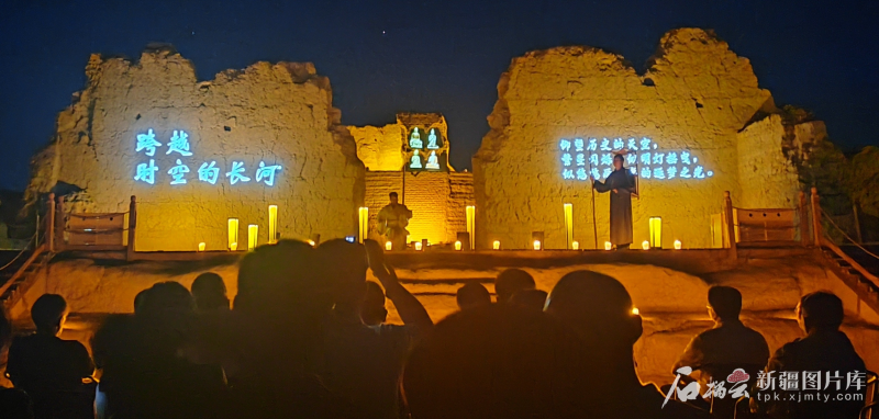 Night Tour of Jiaohe performance with lit earthen walls.