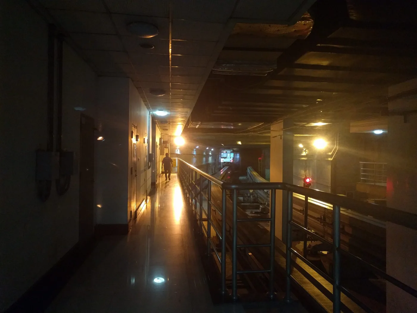 Dimly lit corridor inside Liziba station platform alongside the monorail track.
