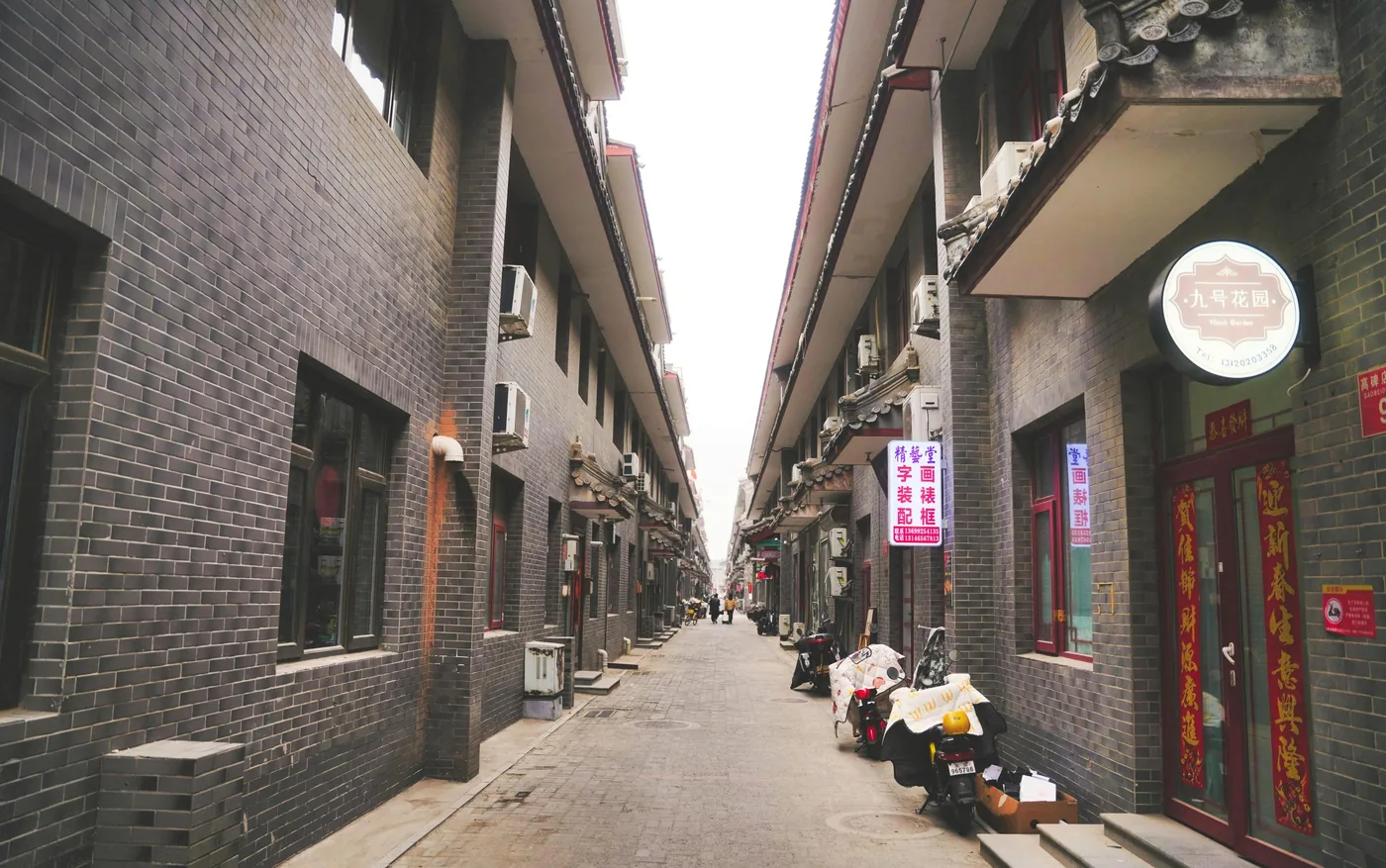 A quiet Beijing alleyway with gray brick architecture and narrow lanes