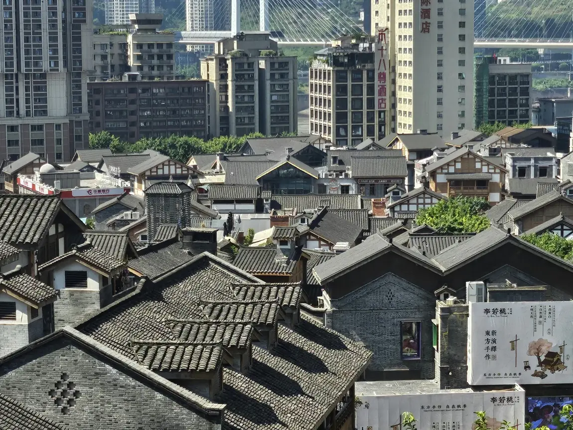 Traditional tiled rooftops in front of modern Chongqing skyscrapers